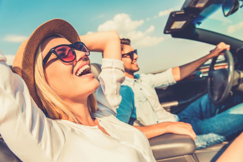 Couple in convertible driving